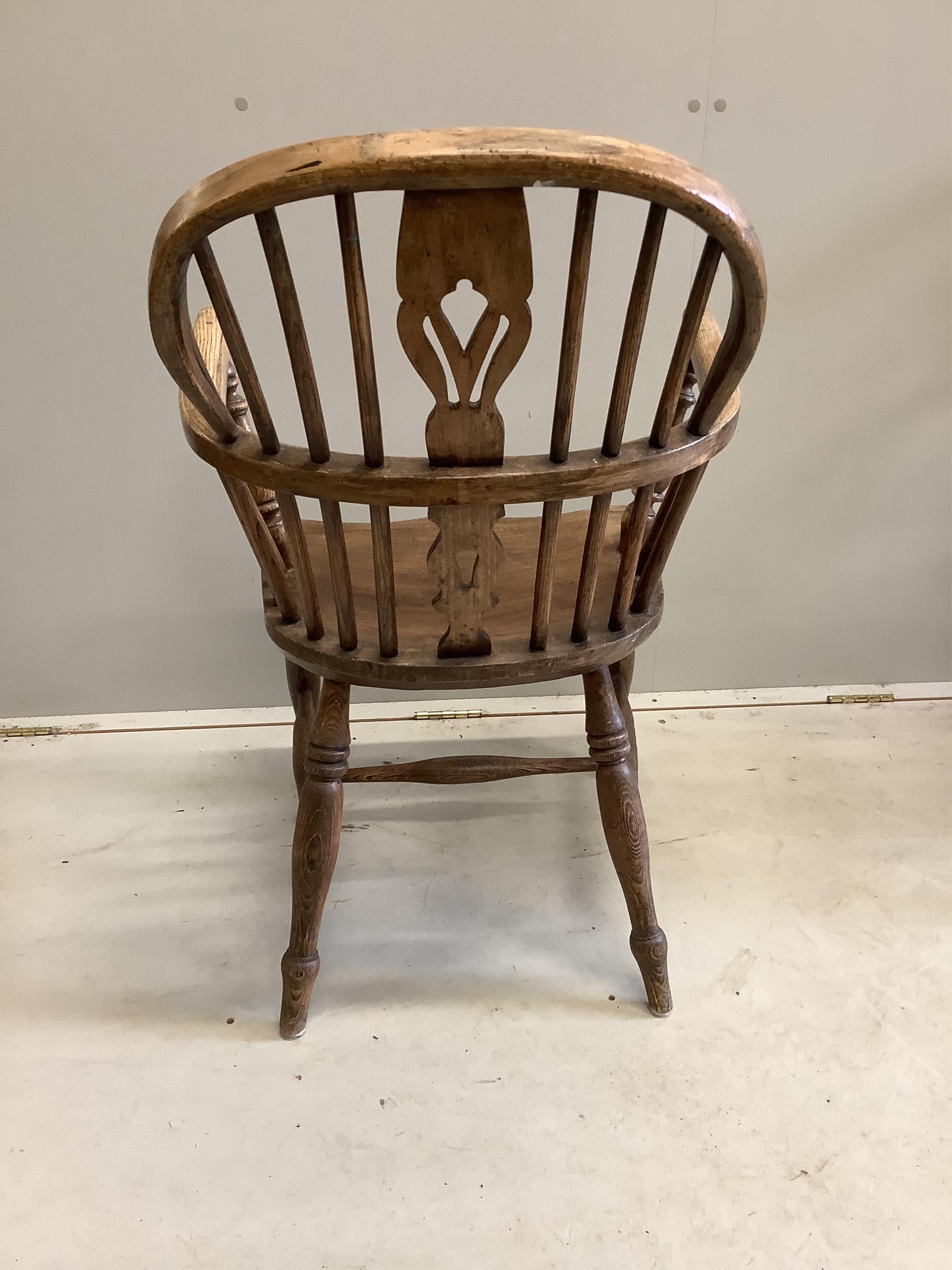 A harlequin set of four 19th century ash, elm and beech Windsor elbow chairs, largest width 60cm, depth 36cm, height 95cm. Condition - fair